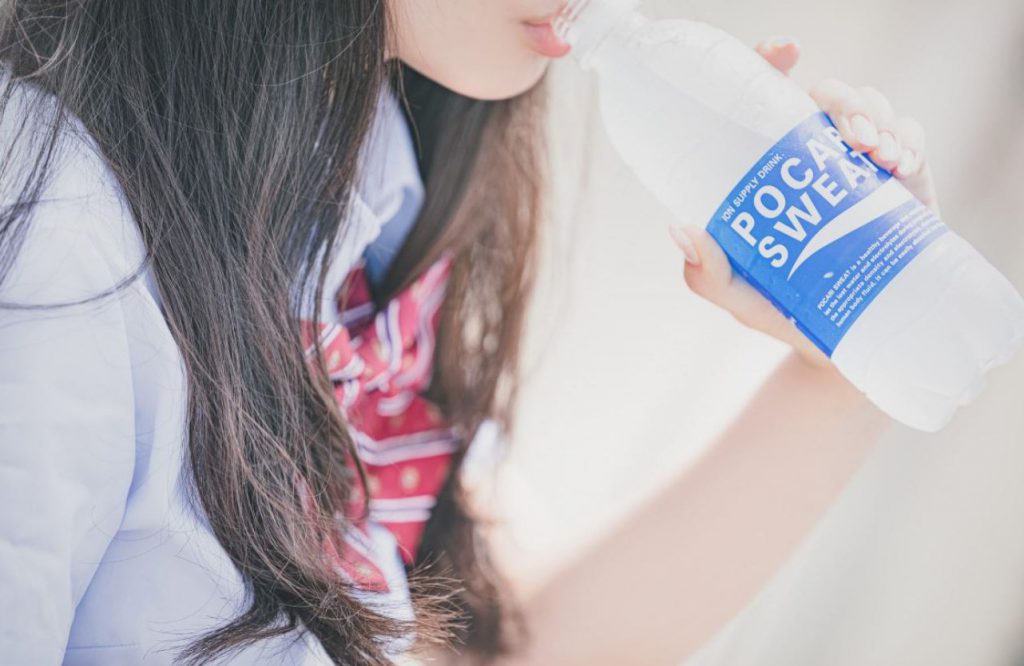 Woman drinking extra ion and electrolyte water