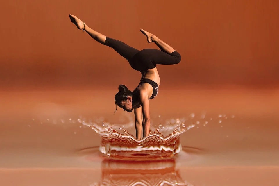 Woman doing a yoga pose splashing water